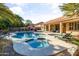 Beautiful pool and spa with lounge chairs and a covered patio at 1007 W Armstrong Way, Chandler, AZ 85286