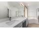 Elegant bathroom with double vanity and soaking tub at 10116 W Luxton Ln, Tolleson, AZ 85353