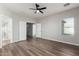 Bright bedroom featuring wood-look floors and large window at 10116 W Luxton Ln, Tolleson, AZ 85353