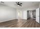 Spacious bedroom with wood-look floors and ceiling fan at 10116 W Luxton Ln, Tolleson, AZ 85353