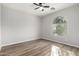 Bright bedroom with wood-look floors and an arched window at 10116 W Luxton Ln, Tolleson, AZ 85353