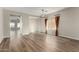 Spacious dining room with wood-look floors, neutral walls, and large windows at 10116 W Luxton Ln, Tolleson, AZ 85353