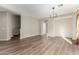 Spacious dining room with wood-look floors, neutral walls, and large windows at 10116 W Luxton Ln, Tolleson, AZ 85353