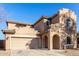 Two-story house with Spanish-style architecture, featuring a large garage and landscaped front yard at 10116 W Luxton Ln, Tolleson, AZ 85353