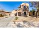 Two-story house with Spanish-style architecture, featuring a large garage and landscaped front yard at 10116 W Luxton Ln, Tolleson, AZ 85353