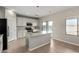 Kitchen with island, stainless steel appliances and pool view at 10116 W Luxton Ln, Tolleson, AZ 85353