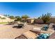 Landscaped backyard with patio furniture and fire pit at 10329 E Sunridge Dr, Sun Lakes, AZ 85248