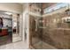 Bathroom with a walk-in shower and tiled walls at 10329 E Sunridge Dr, Sun Lakes, AZ 85248