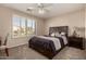 Bright bedroom with a queen-size bed and window shutters at 10329 E Sunridge Dr, Sun Lakes, AZ 85248