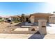 Single-story home with desert landscaping and a two-car garage at 10329 E Sunridge Dr, Sun Lakes, AZ 85248