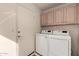 Laundry room with washer, dryer, and overhead cabinets at 10329 E Sunridge Dr, Sun Lakes, AZ 85248