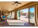 Sunroom with sliding glass doors opening to backyard at 10329 E Sunridge Dr, Sun Lakes, AZ 85248