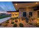 Landscaped backyard with stone patio, fire pit, and modern lighting at 10709 E Thornton Ave, Mesa, AZ 85212