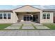 Covered patio with herringbone pavers, artificial turf, and sliding glass doors at 10709 E Thornton Ave, Mesa, AZ 85212