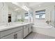 Elegant bathroom with double vanity, soaking tub, and walk-in shower at 10709 E Thornton Ave, Mesa, AZ 85212