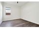 Well-lit bedroom featuring wood-look floors and a window at 10709 E Thornton Ave, Mesa, AZ 85212