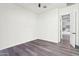 Bright bedroom with wood-look flooring and ceiling fan at 10709 E Thornton Ave, Mesa, AZ 85212