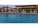 Resort-style pool with a clubhouse and shaded seating areas at 10709 E Thornton Ave, Mesa, AZ 85212