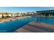 Large community pool with plenty of lounge chairs and shade structures at 10709 E Thornton Ave, Mesa, AZ 85212