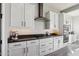 Modern kitchen featuring white cabinets, dark countertops, and stainless steel appliances at 10709 E Thornton Ave, Mesa, AZ 85212