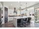 Modern kitchen with white cabinets, quartz countertops, and island at 10709 E Thornton Ave, Mesa, AZ 85212