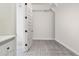 Bright laundry room with patterned tile floor and white cabinets at 10709 E Thornton Ave, Mesa, AZ 85212