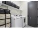 Laundry room with washer, dryer, and storage shelves at 10709 E Thornton Ave, Mesa, AZ 85212