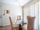 Cozy dining area with a glass table and four cushioned chairs at 10742 W Cheryl Dr, Sun City, AZ 85351