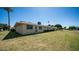 Back exterior view of a ranch-style home with a large lawn at 10742 W Cheryl Dr, Sun City, AZ 85351