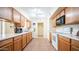 Bright kitchen with light wood cabinets and tile floor at 10742 W Cheryl Dr, Sun City, AZ 85351