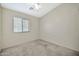 Well-lit bedroom featuring a window with blinds at 10932 W Morten Ave, Glendale, AZ 85307