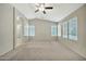 Bright and airy bedroom with ceiling fan and carpet flooring at 10932 W Morten Ave, Glendale, AZ 85307