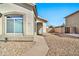 Front entrance with a teal door and stone pathway at 10932 W Morten Ave, Glendale, AZ 85307