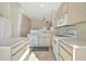 Kitchen features light wood cabinets, tile flooring, and a dishwasher at 10932 W Morten Ave, Glendale, AZ 85307