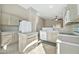 Kitchen with light wood cabinets, island and appliances at 10932 W Morten Ave, Glendale, AZ 85307