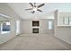 Living room with fireplace, ceiling fan, and access to backyard at 10932 W Morten Ave, Glendale, AZ 85307