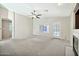 Spacious living area with carpet, fireplace and door to patio at 10932 W Morten Ave, Glendale, AZ 85307