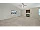 Spacious living room featuring a fireplace and ceiling fan at 10932 W Morten Ave, Glendale, AZ 85307