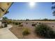 Landscaped backyard with golf course view and desert landscaping at 11250 E Kilarea E Ave # 216, Mesa, AZ 85209