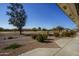 Landscaped backyard with golf course view and desert landscaping at 11250 E Kilarea E Ave # 216, Mesa, AZ 85209