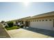 Side view of a house showcasing attached garage and neat landscaping at 11250 E Kilarea E Ave # 216, Mesa, AZ 85209