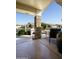 Inviting covered porch with stone pillars, comfortable seating, and lush greenery at 11250 E Kilarea E Ave # 216, Mesa, AZ 85209