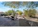 Relaxing backyard oasis with lounge chairs and a water feature at 12056 E Bella Vista Cir, Scottsdale, AZ 85259