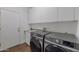 Bright laundry room with modern washer and dryer, cabinets and sink at 12056 E Bella Vista Cir, Scottsdale, AZ 85259