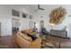 Tan leather sectional and wood coffee table in a living room with high ceilings at 12056 E Bella Vista Cir, Scottsdale, AZ 85259