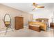 Main bedroom with wood furniture and ceiling fan at 12059 S Paiute St, Phoenix, AZ 85044