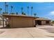 House exterior featuring a stone facade, attached garage and desert landscaping at 12059 S Paiute St, Phoenix, AZ 85044