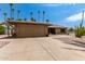 Landscaped front yard with a two-car garage and stone exterior at 12059 S Paiute St, Phoenix, AZ 85044