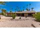 Front view of a ranch-style house with stone accents and drought-tolerant landscaping at 12059 S Paiute St, Phoenix, AZ 85044