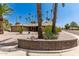 House exterior with stone facade, mature landscaping, and a curved brick wall at 12059 S Paiute St, Phoenix, AZ 85044